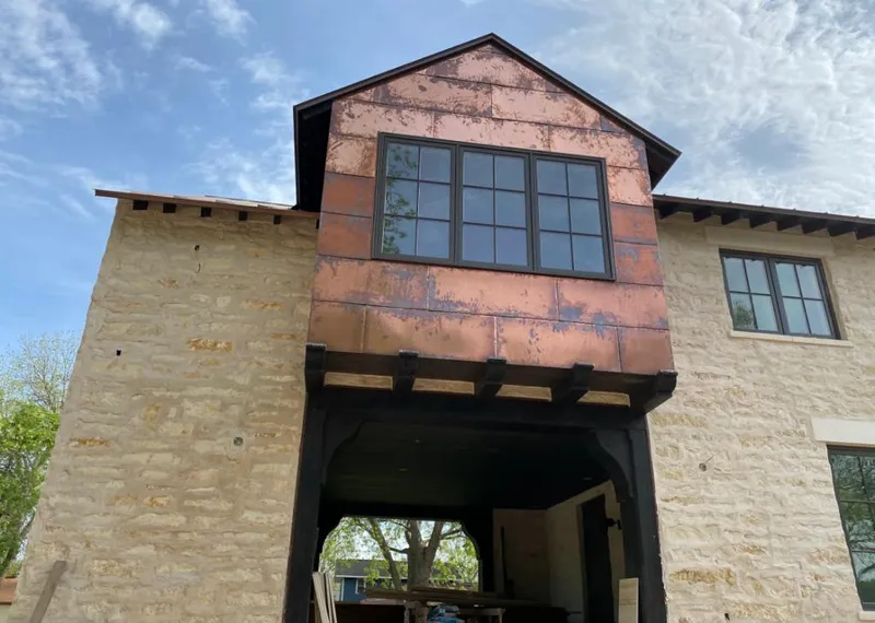 Copper metal panel facade on a stone building for Skylight Installation in Farmington